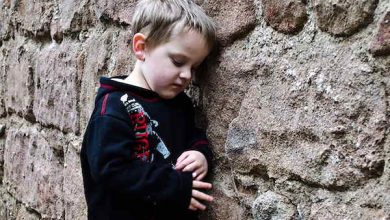 boy leaning against wall